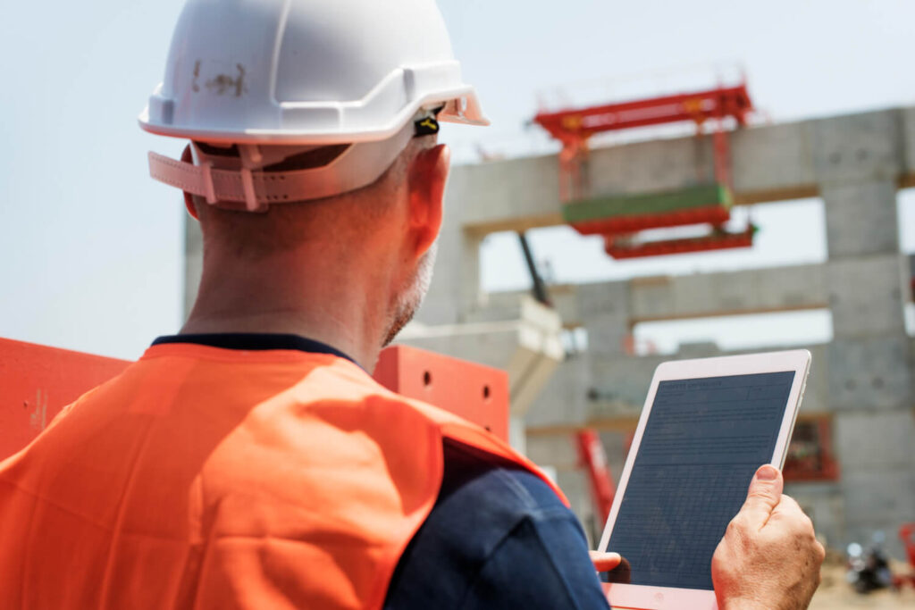 Construction worker using a tablet on site to work more productively