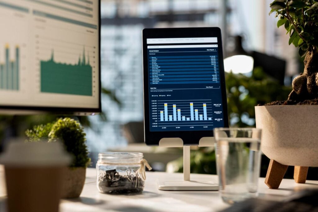 Business dashboards on a monitor and tablet, planning a mobile app for long-term success