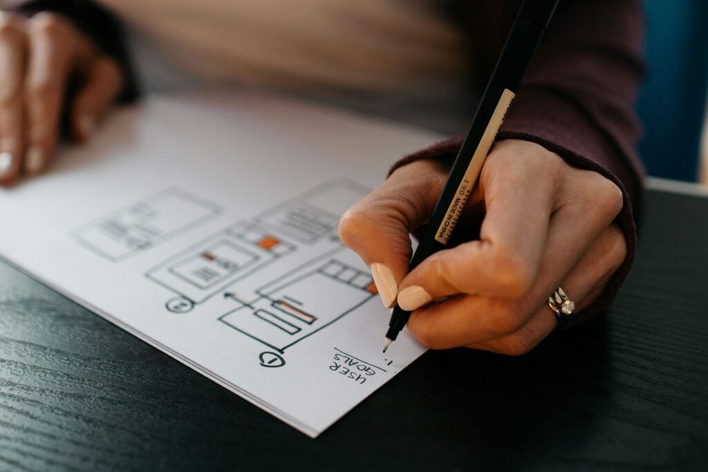 Hand sketching a system diagram to avoid wasting money on ineffective tech