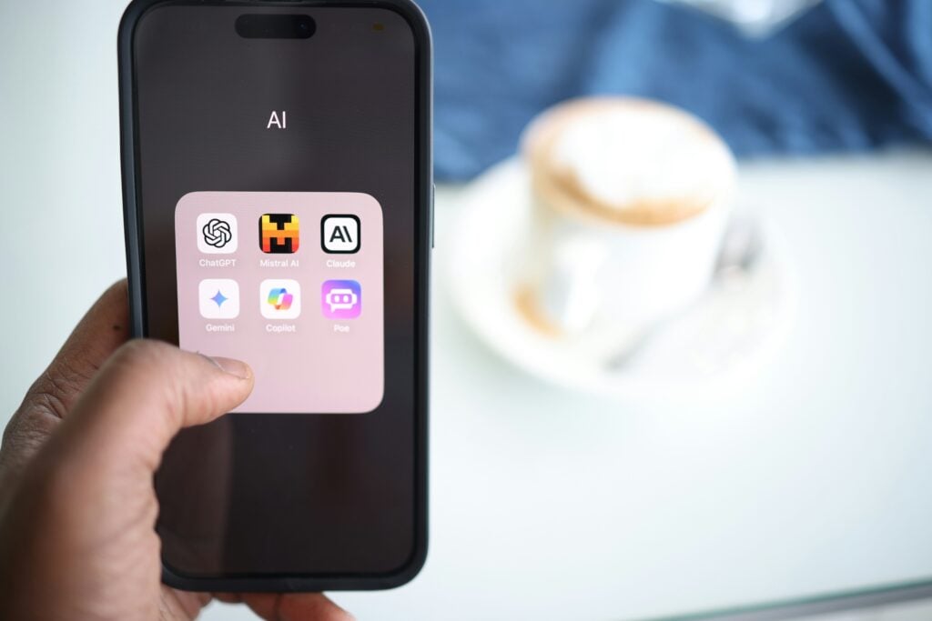 Phone showing a folder of AI apps, as AI moves from experiment to enterprise value