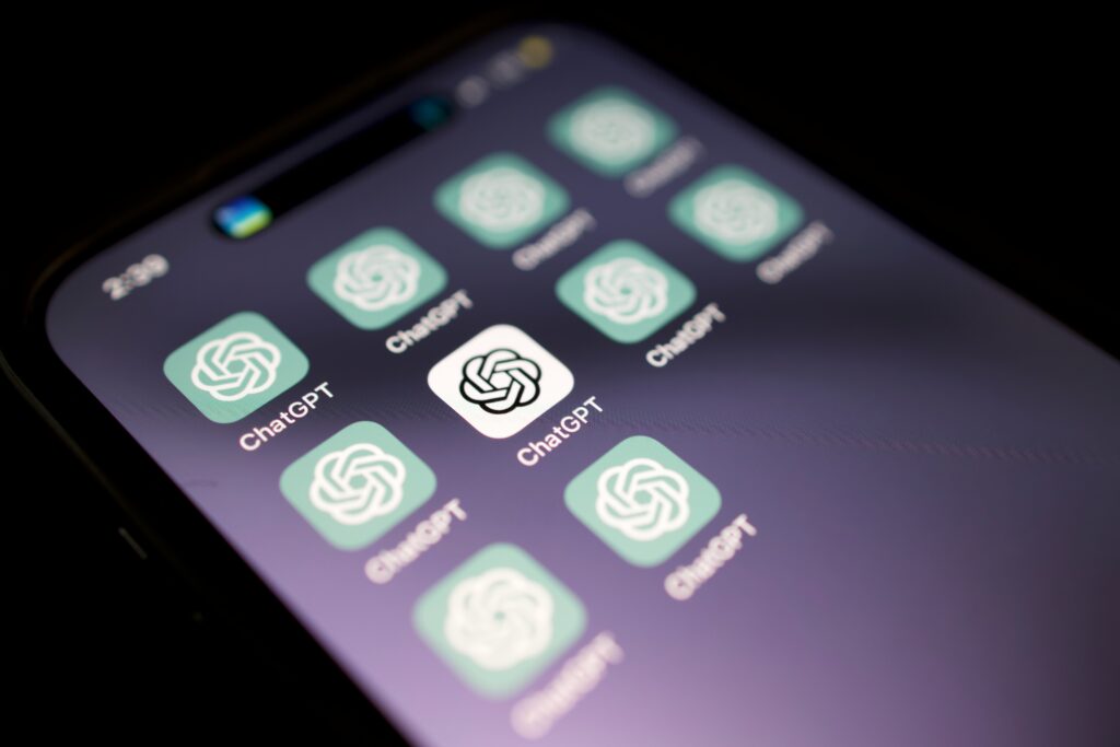Phone screen of ChatGPT app icons, representing AI in enterprise UX