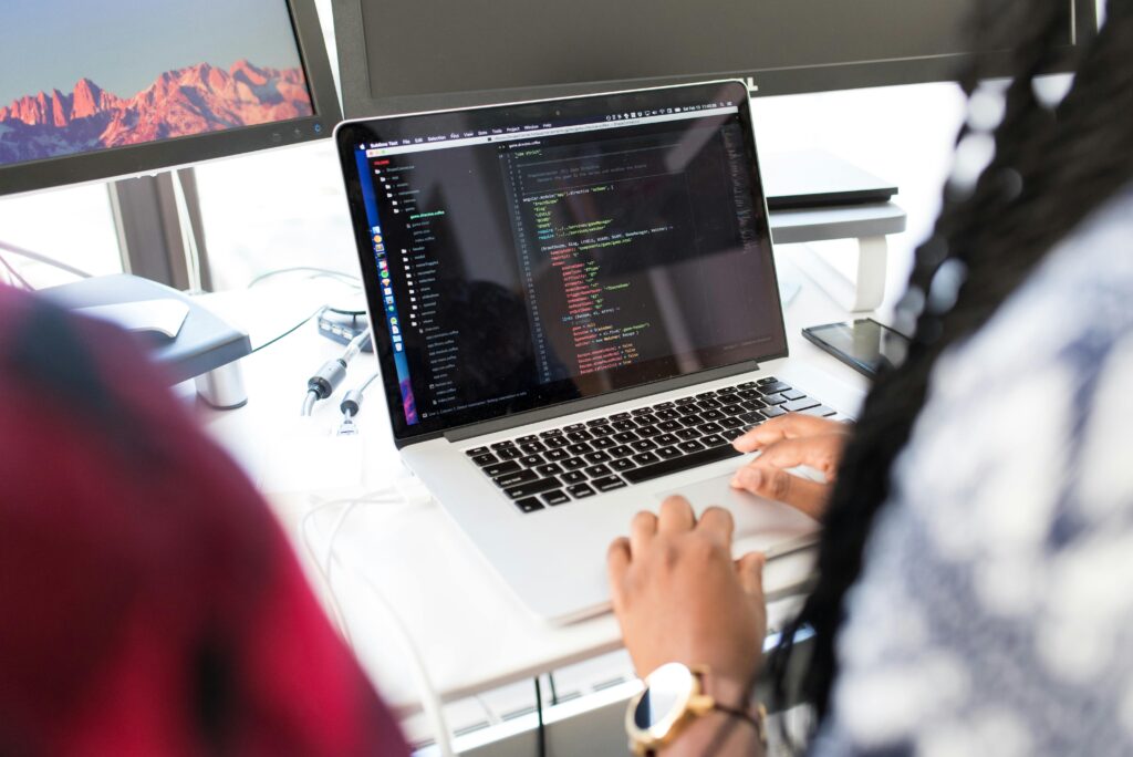 Developers working on code, deciding whether an app is an asset or an expense