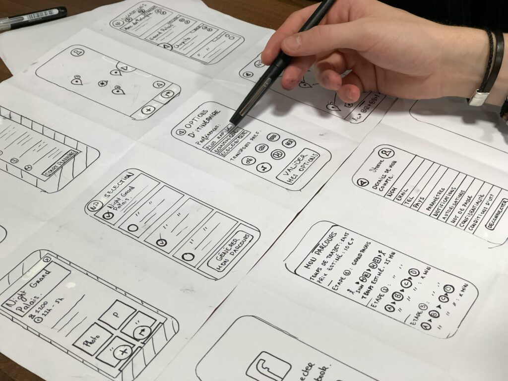 Hand sketching app wireframes, an early step in creating a lasting design system