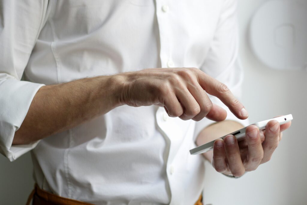 Man using a smartphone, considering whether his app actually needs AI