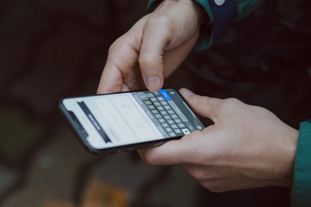 Person typing on a phone, the everyday user an enterprise app needs to win over