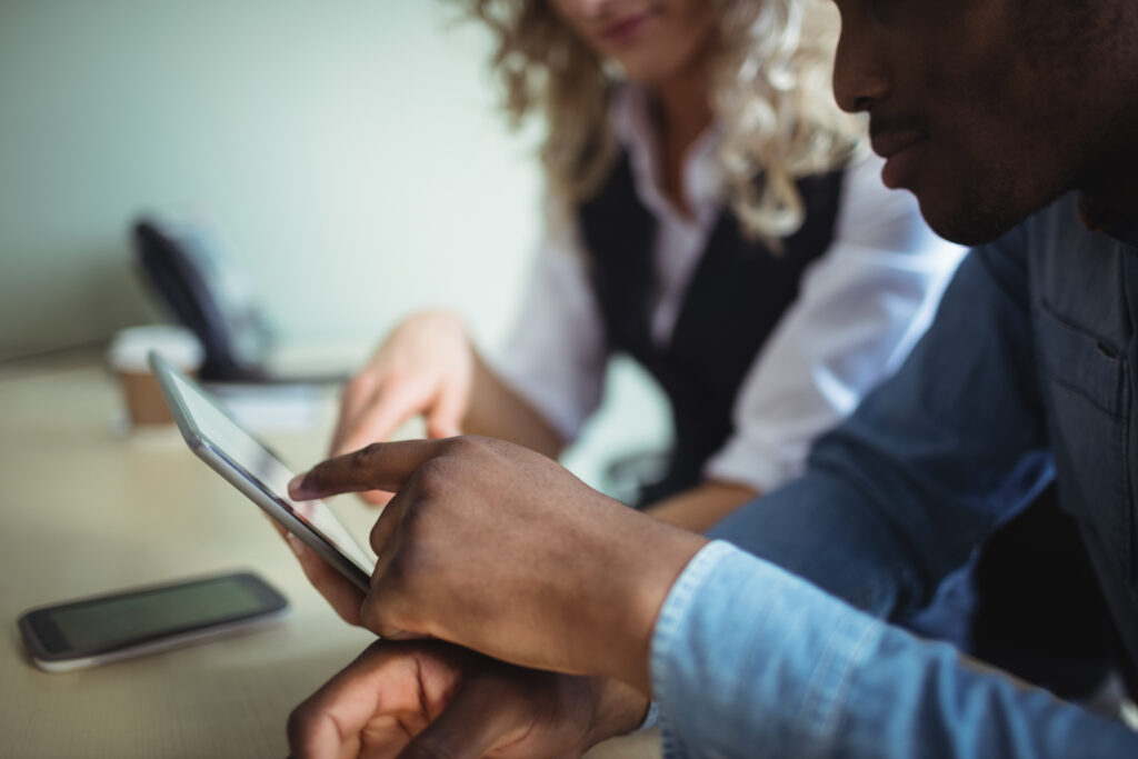 Colleagues reviewing a tablet to decide when event-driven architecture adds value
