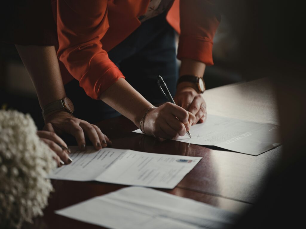 People reviewing and signing documents, as governance becomes part of product design