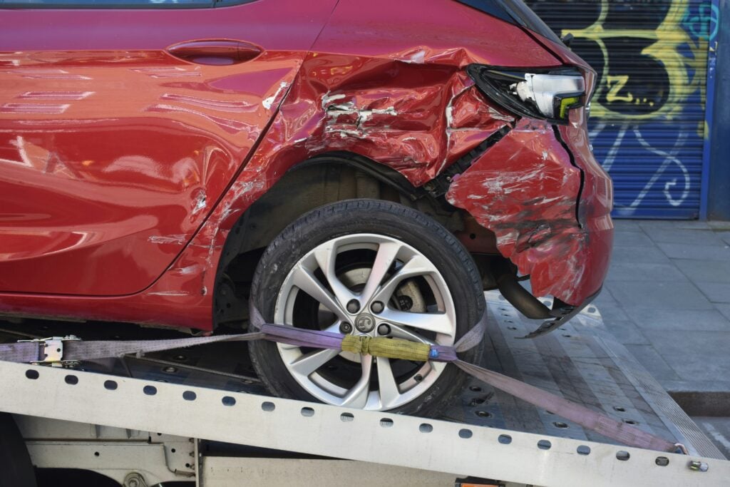 Damaged car on a recovery truck, the stressful moment insurance platforms must be designed for