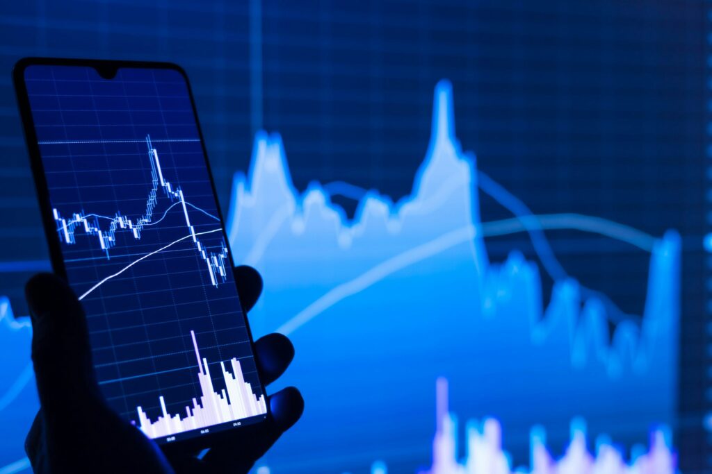 Phone showing financial charts, as neobanks face the pressures of becoming incumbents