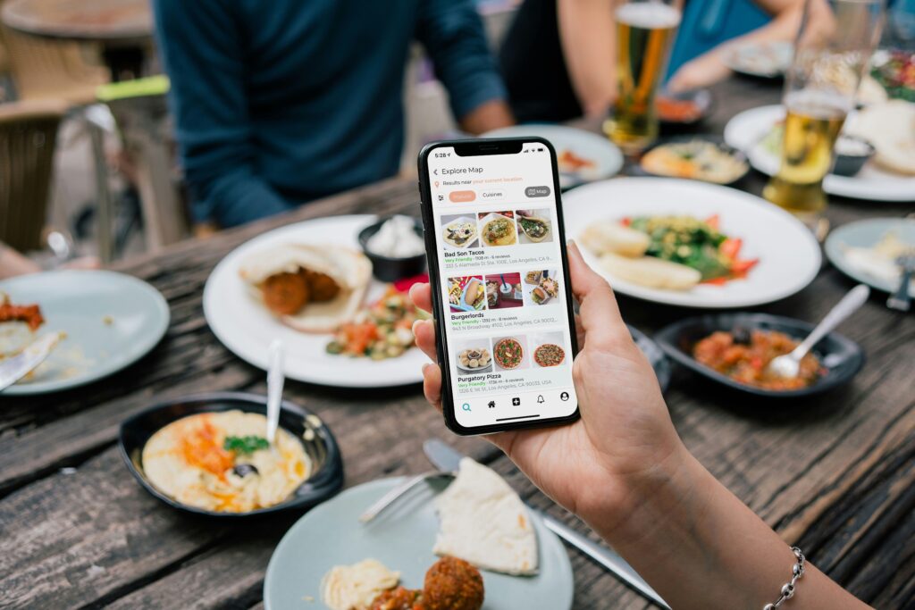 Person browsing a food ordering app, showing onboarding in a real-world setting