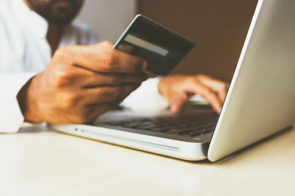 Person paying online with a card, where Open Banking 2.0 consent and control matter